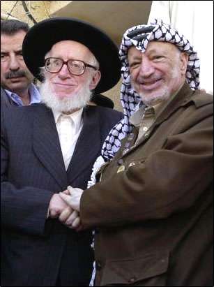 RAbbi Moishe Hirsch shaking hands with Yasser Arafat.